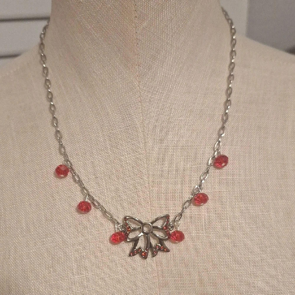 Elegant Silver and Red Bow Necklace